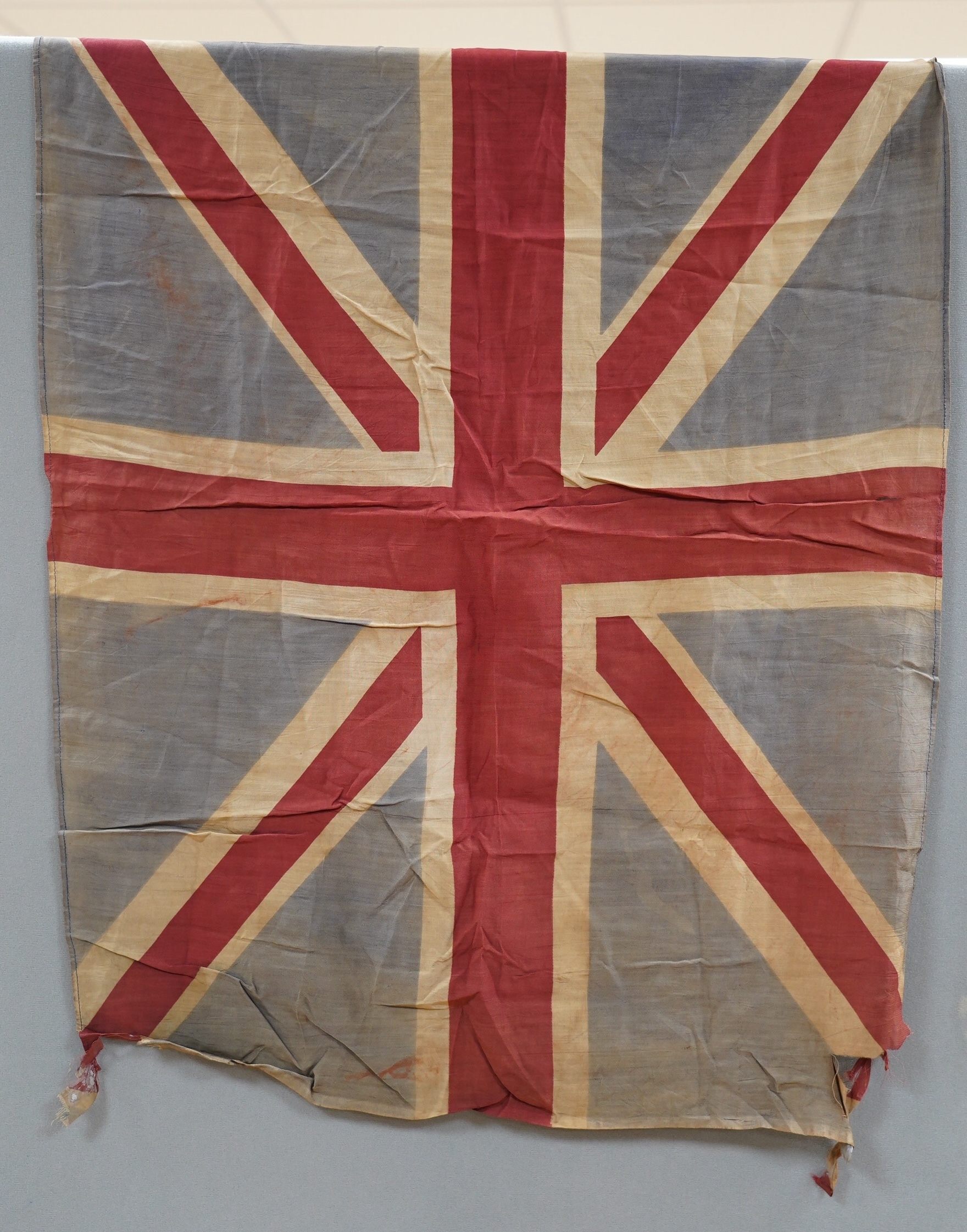 Eight mostly mid 20th century Union Jack flags, one celebrating Queen Victoria’s Diamond Jubilee, together with a Saint George’s cross and a string of Union flag bunting. Condition - poor to good